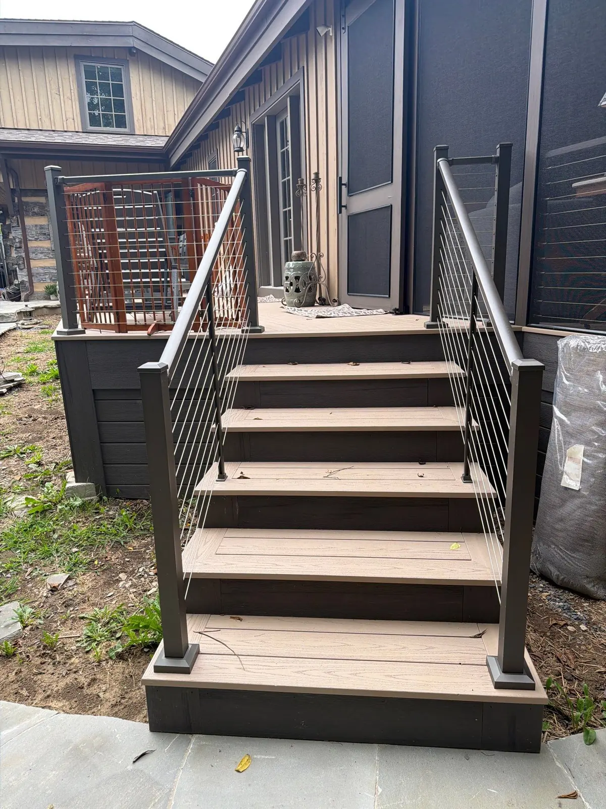 Composite stairs with black posts and cable railing