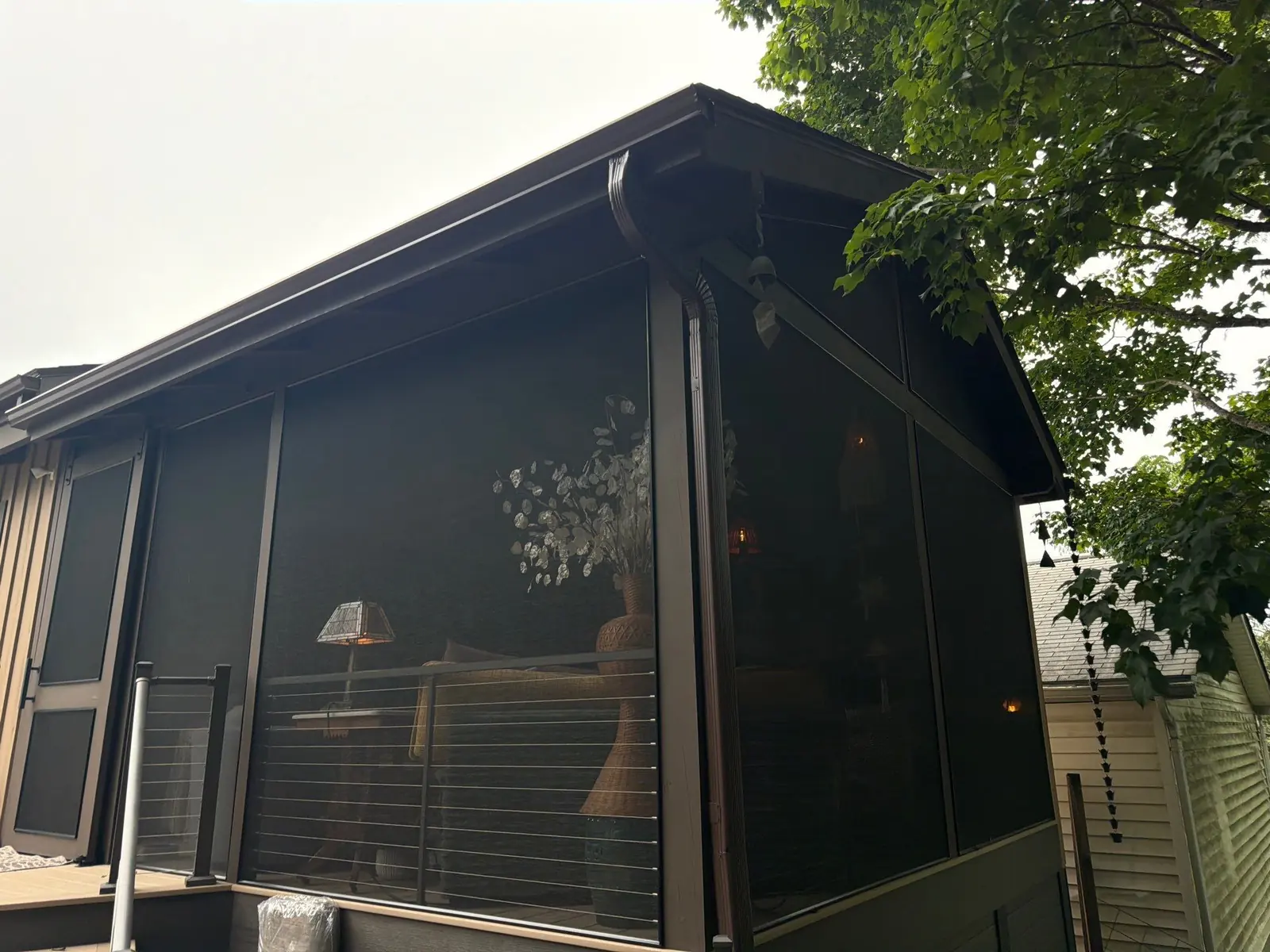 Modern dark-framed screen room with glass doors