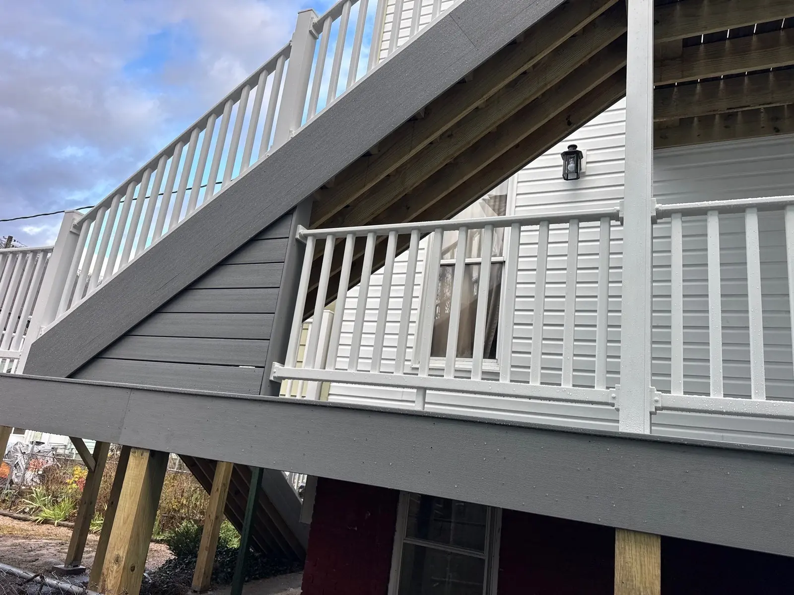 Multi-level composite deck stairs with white vinyl railing