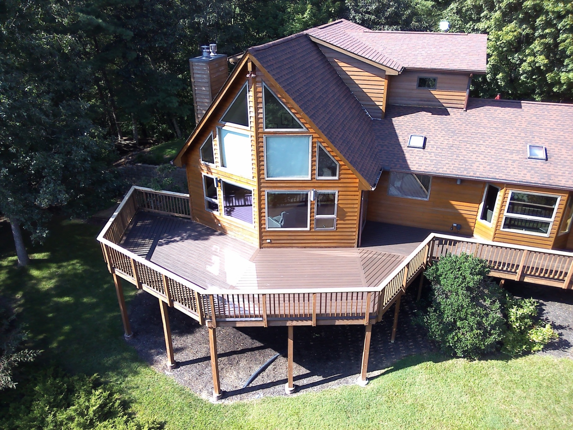 Aerial view of wraparound deck on A-frame home