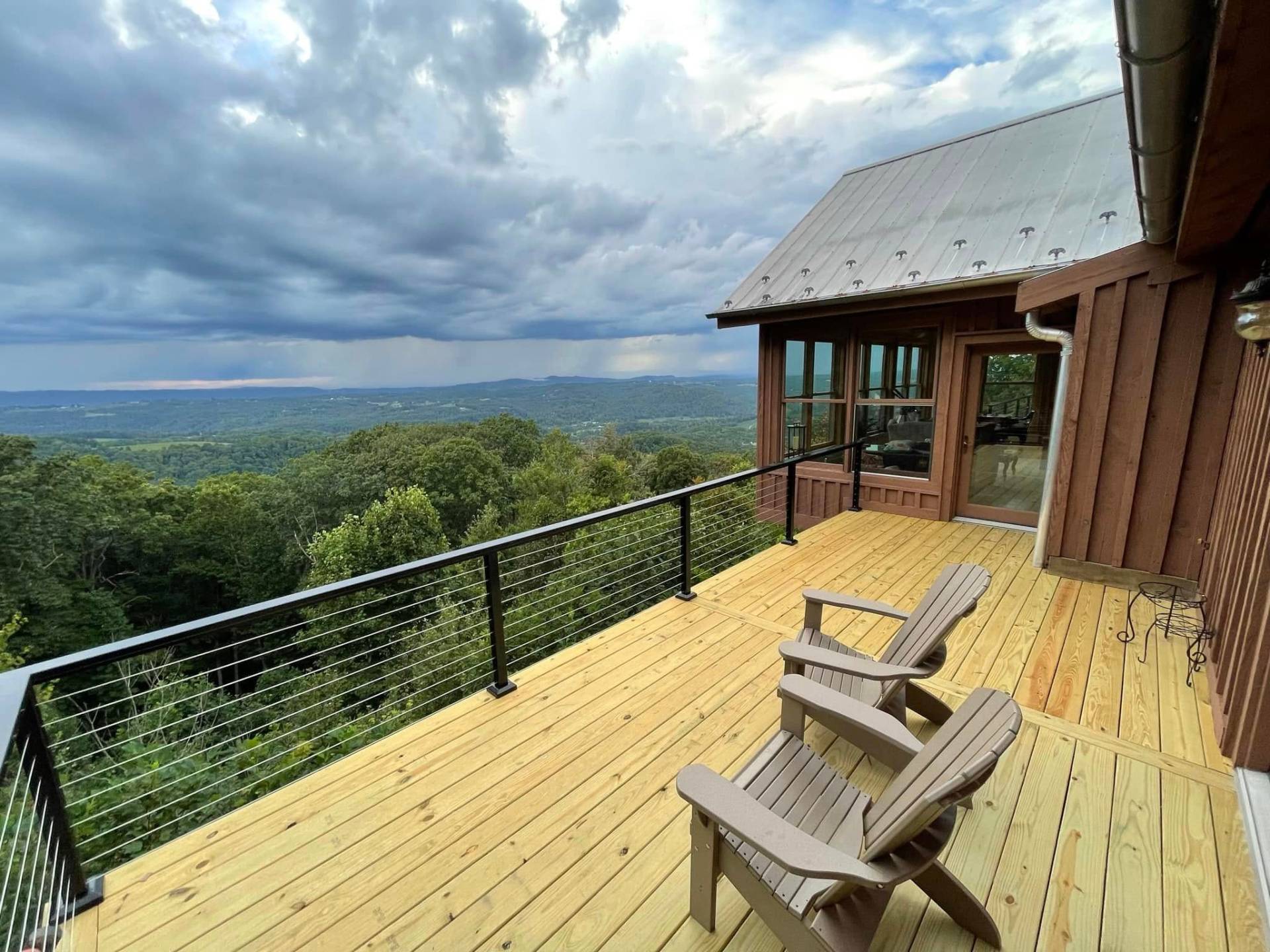 Mountain deck with Adirondack chairs and panoramic view