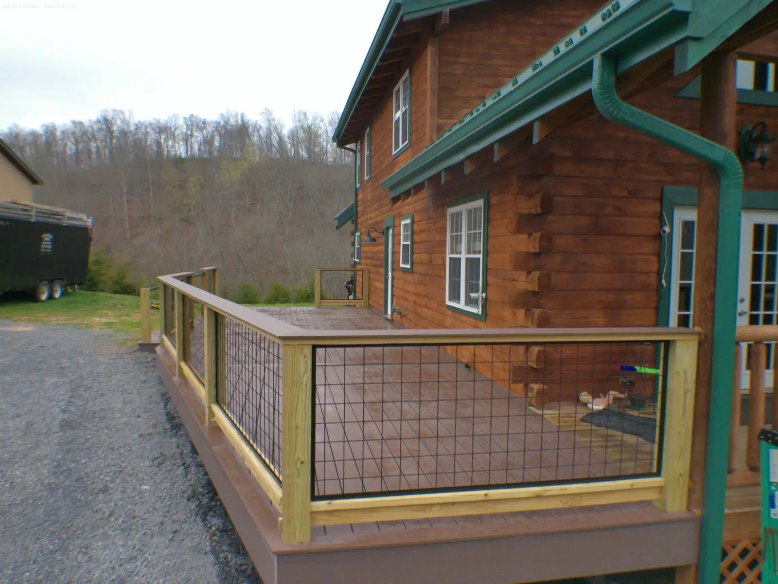 Log cabin deck with wire panel railing