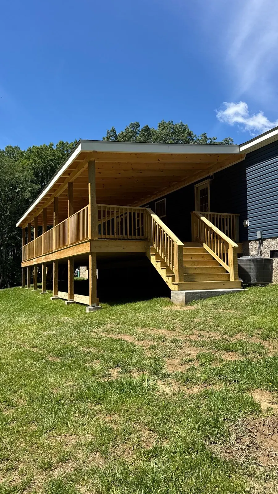 Pressure-treated wood deck with covered pavilion and staircase